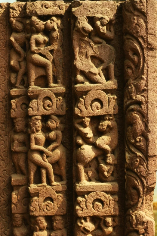 a stone carving with animals and people on it