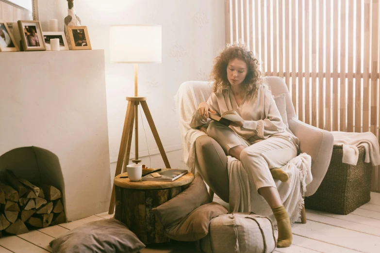 a woman sitting on top of a white couch in a living room