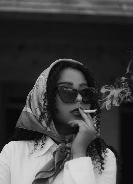 a woman in white is smoking a cigarette