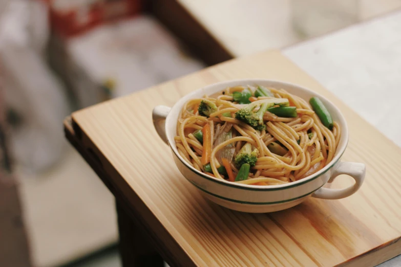 the bowl is filled with noodles and broccoli