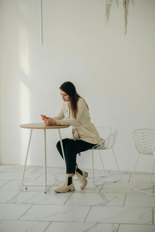 woman at a small table with chairs in a room