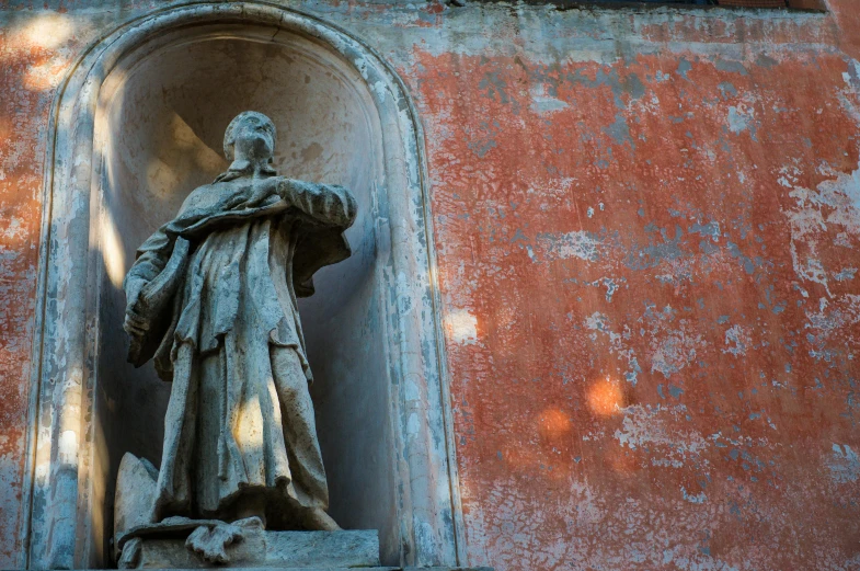 a statue on a pedestal outside a building