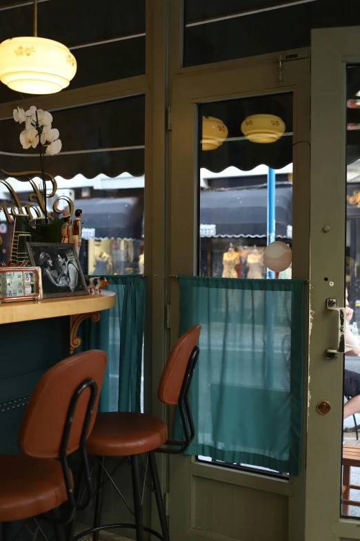 a restaurant with green curtains and blue curtains