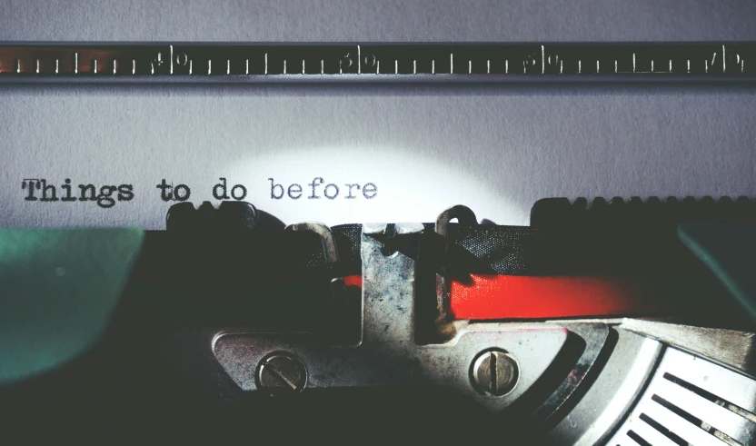 a typewriter with a red rubber and a ruler