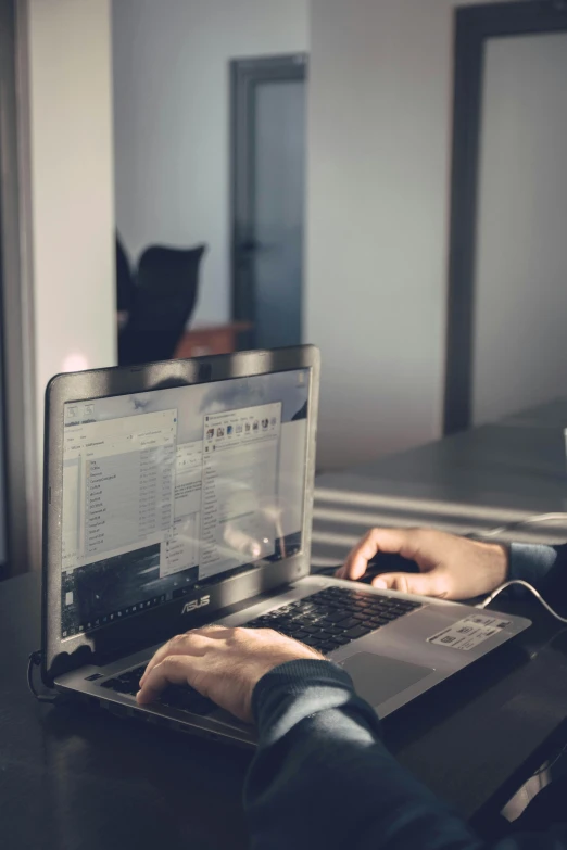 person working on computer with headphones at table