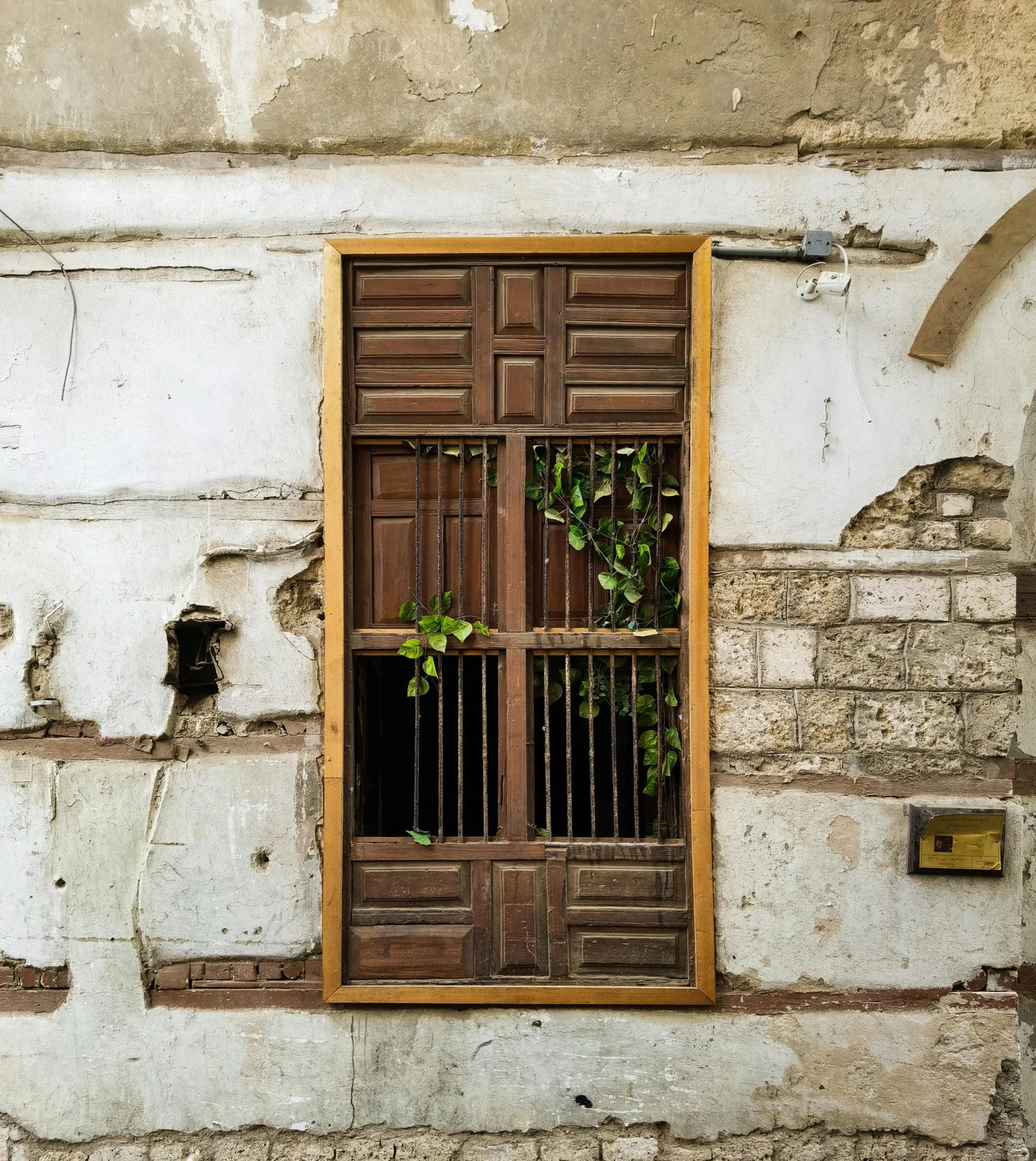 a building with a window and iron bars