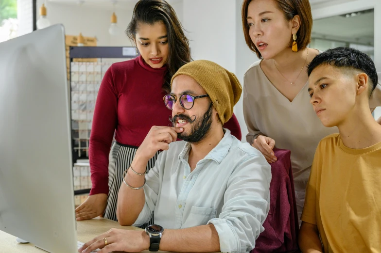 people that are looking at a laptop together