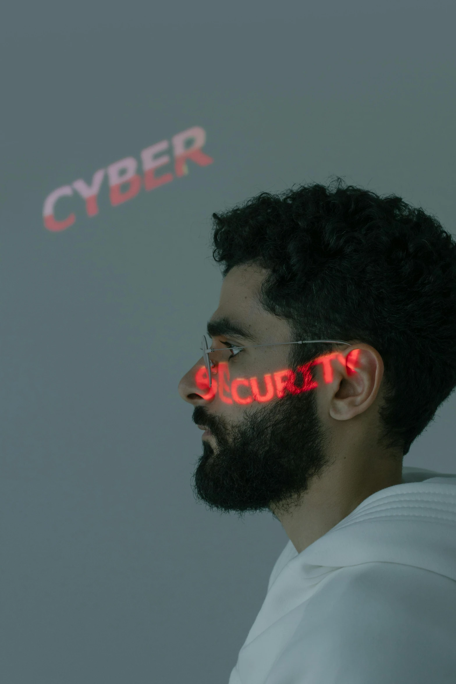 a man standing with his eyes lit up and the word cyber above him