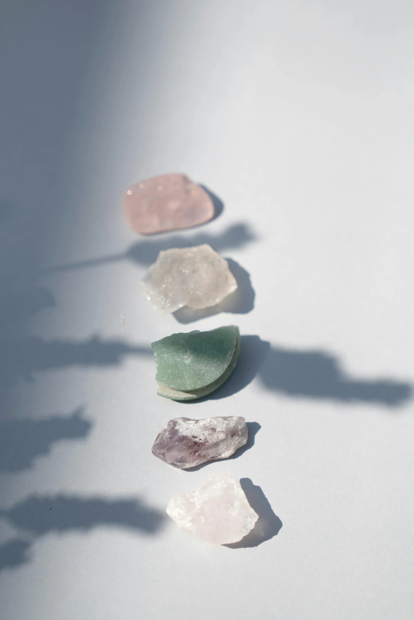 three rocks with some pink, white, and green rocks