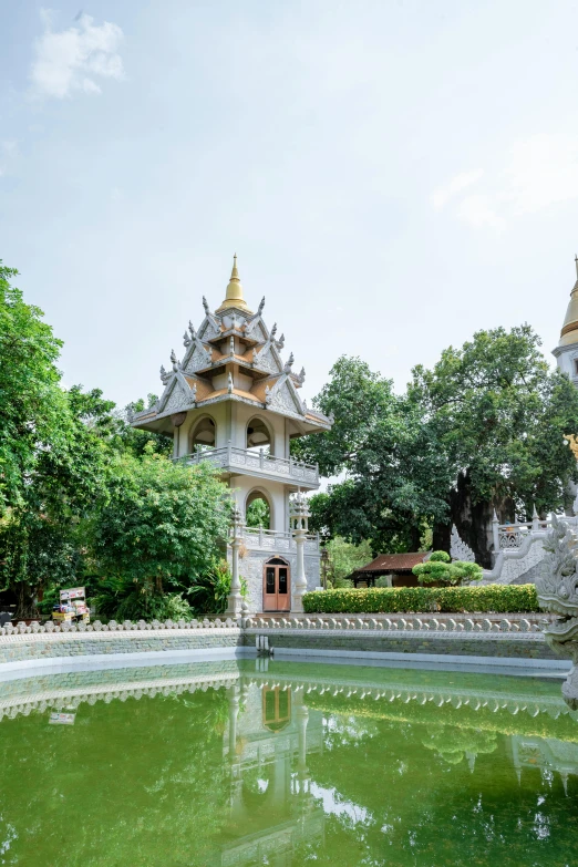 an ornate garden scene with water reflecting the building