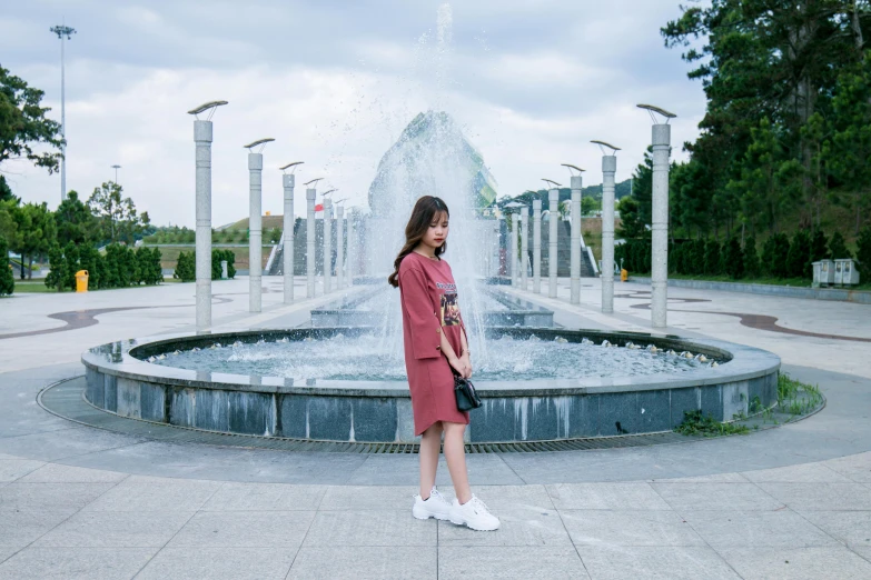  standing in front of water fountain