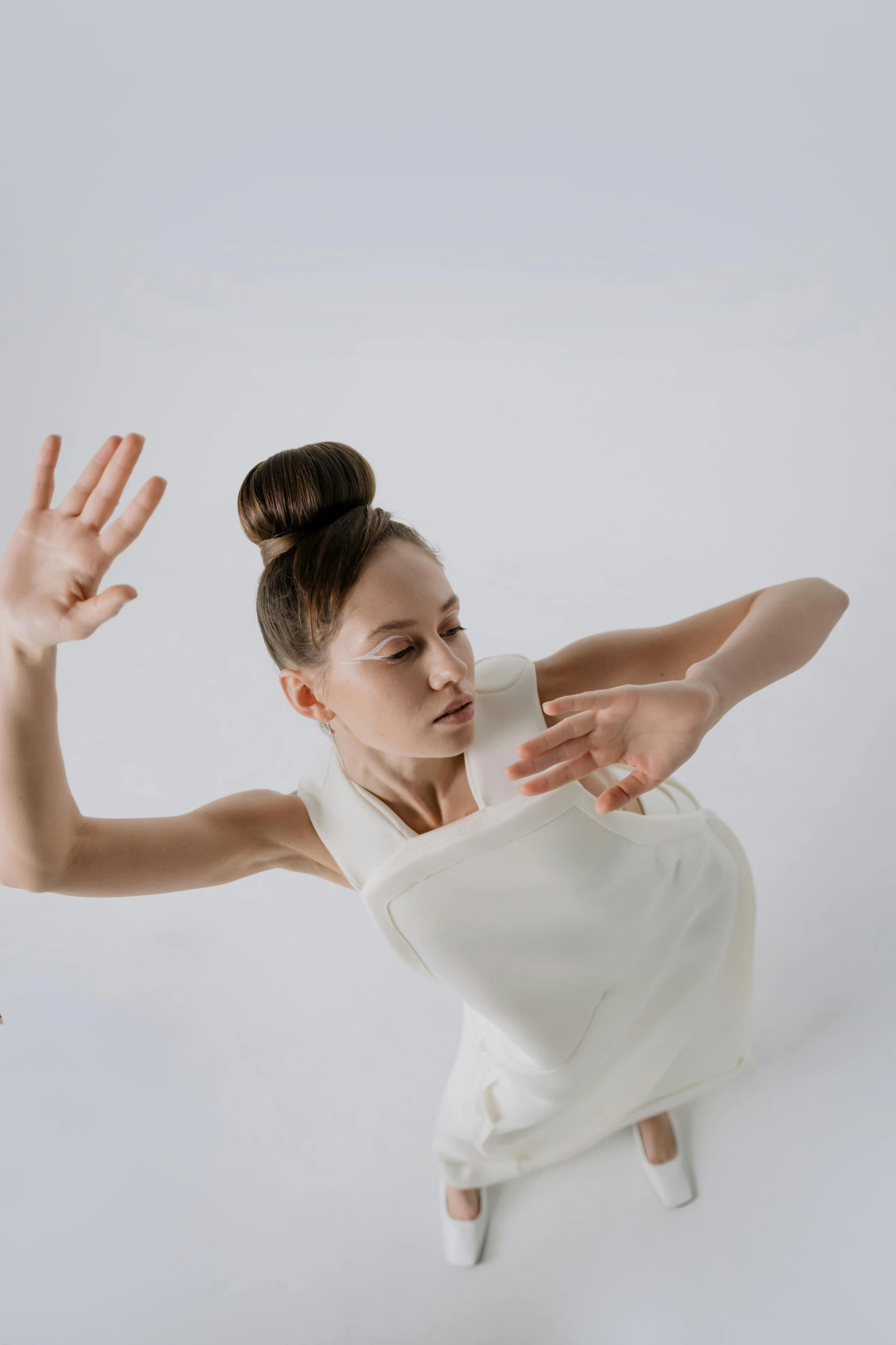 a person in a white shirt doing a dance pose