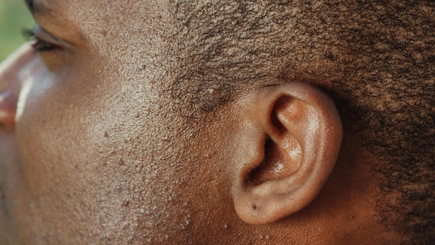 closeup of ear with brown dirt and grass on it