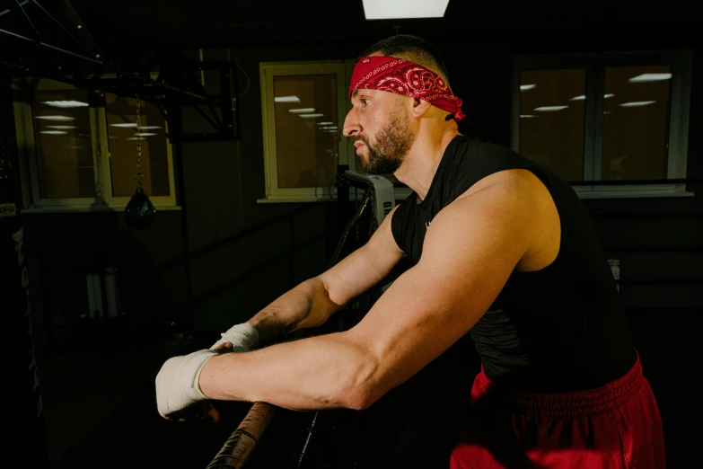 the man is holding his equipment in an exercise room