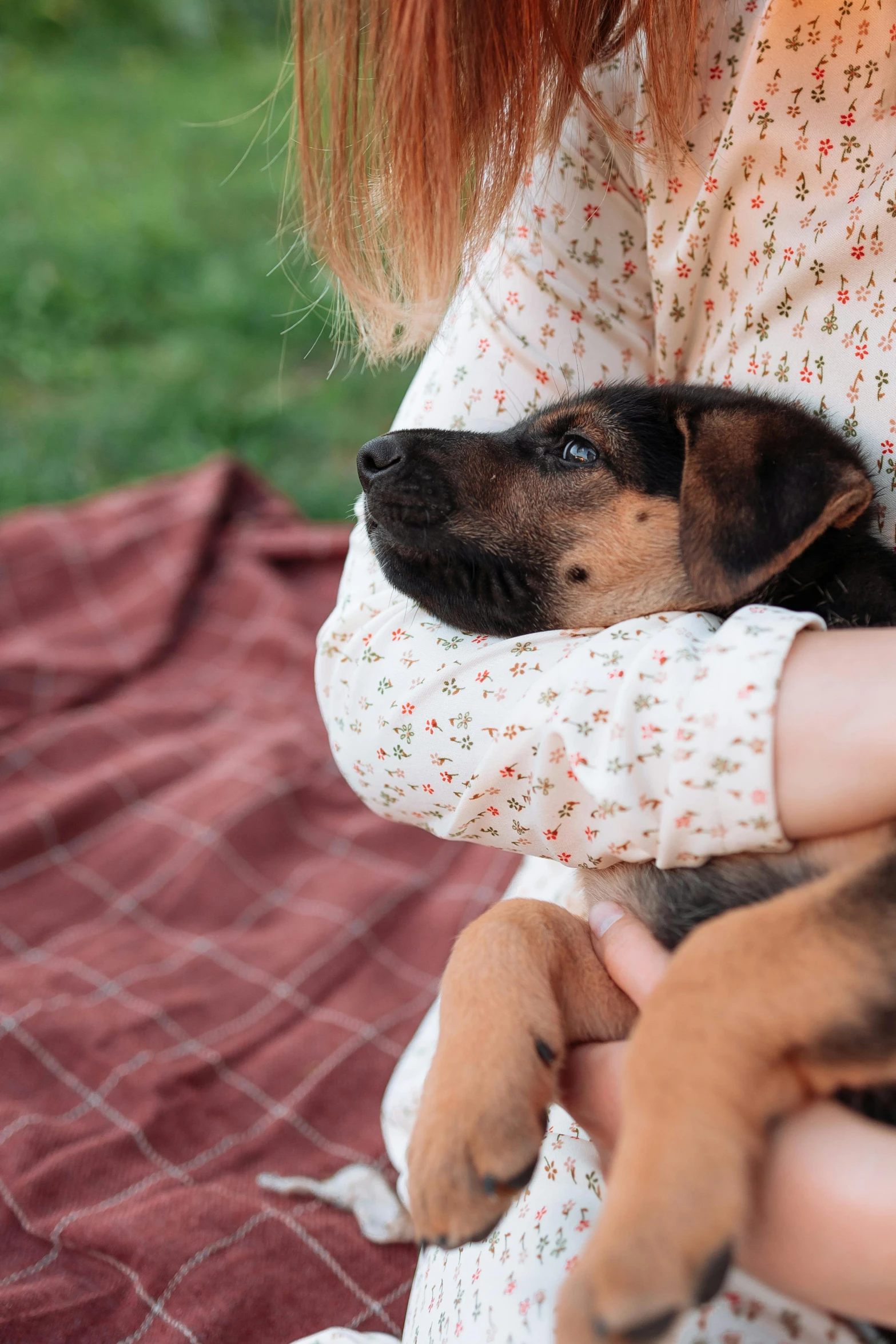 a woman with a puppy is holding her baby