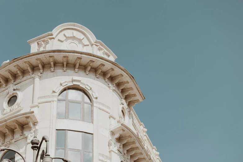 a clock is in front of a white building