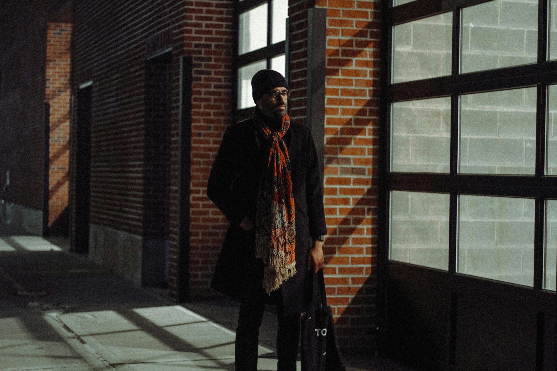 an image of a man standing on a sidewalk with his suit case