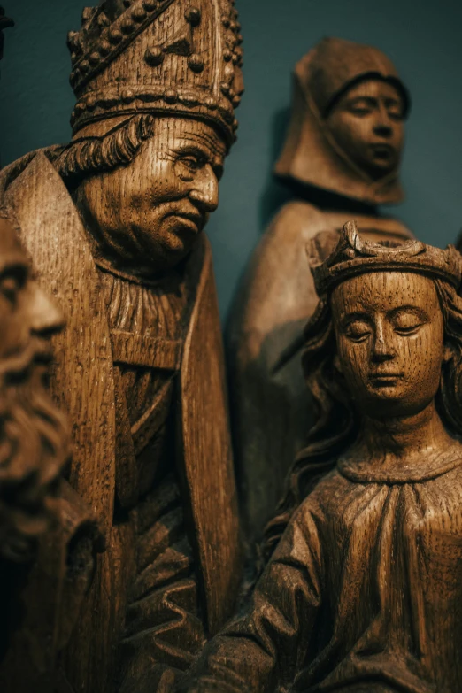 statues of people standing near each other in wooden