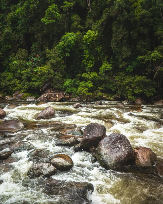 a man with a backpack looking at some rapids