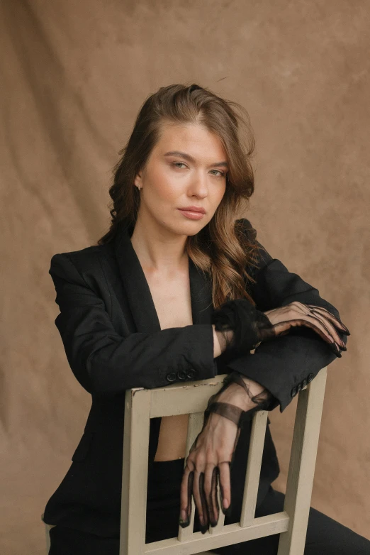 a woman sitting in a chair with long hair