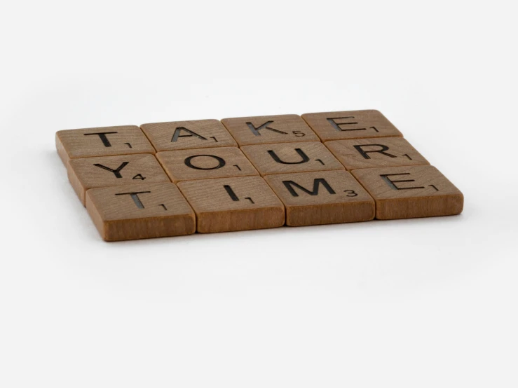 a close up of a block of wood with words that read'make your time '