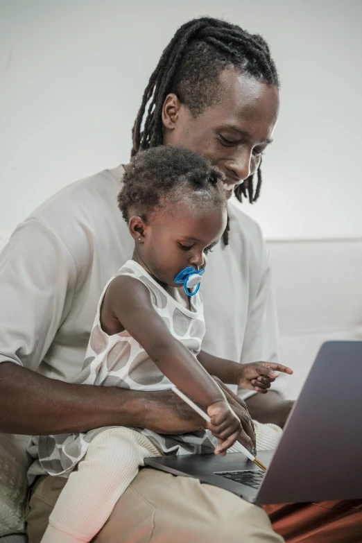 an adult and child using a computer together