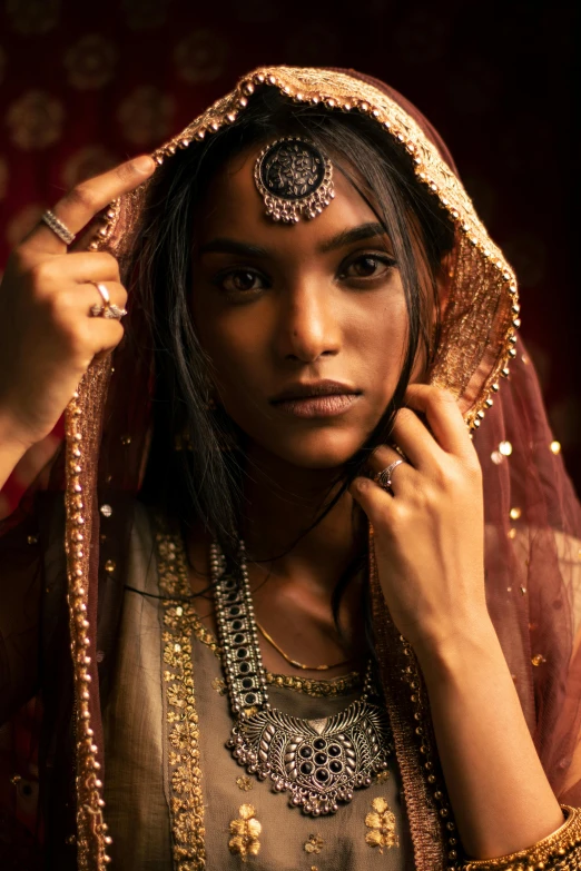 a beautiful young woman in sari with head piece