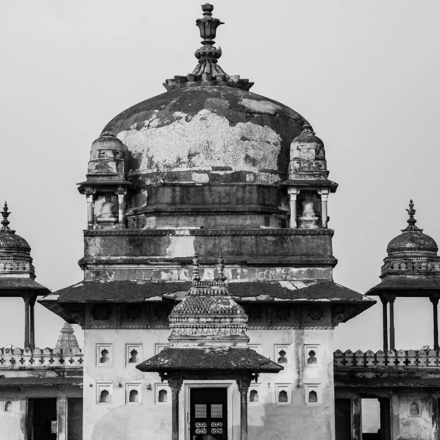 the tall tower has an intricate dome on top