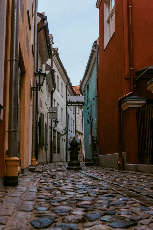 an empty street in between two buildings on either side of the road