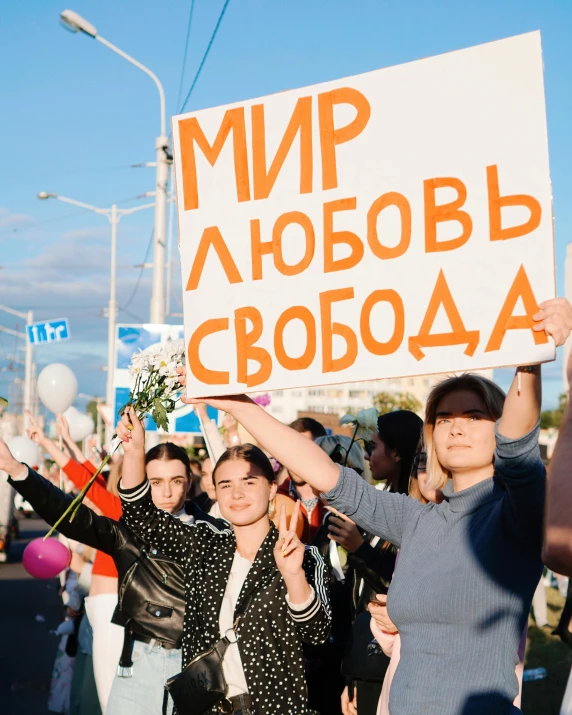 a group of girls holding up signs protesting for a political contest