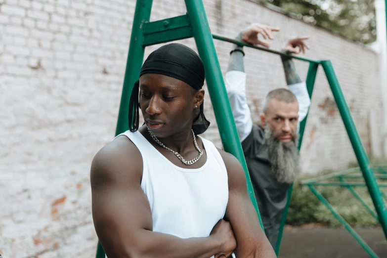 an african man leans on a handrail as another holds his head in the background