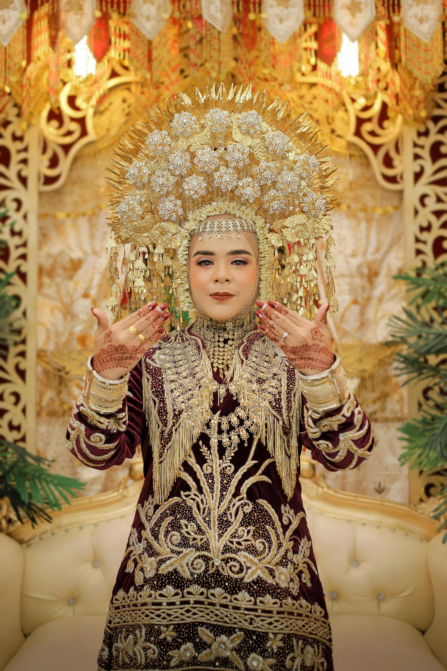 a beautiful young lady wearing an elaborate dress and headdress