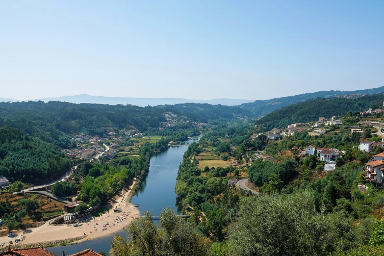 the river running through a valley in front of the village