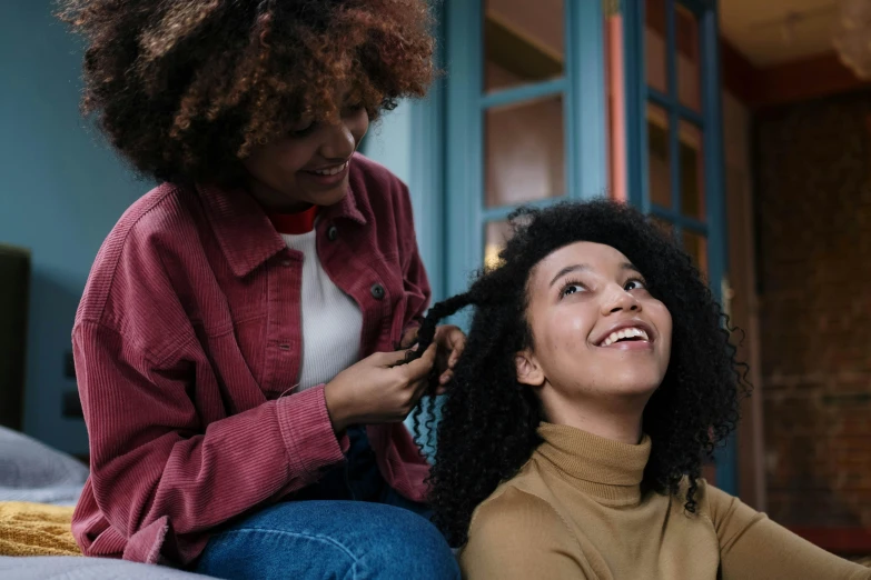 a woman getting her hair cut at a salon