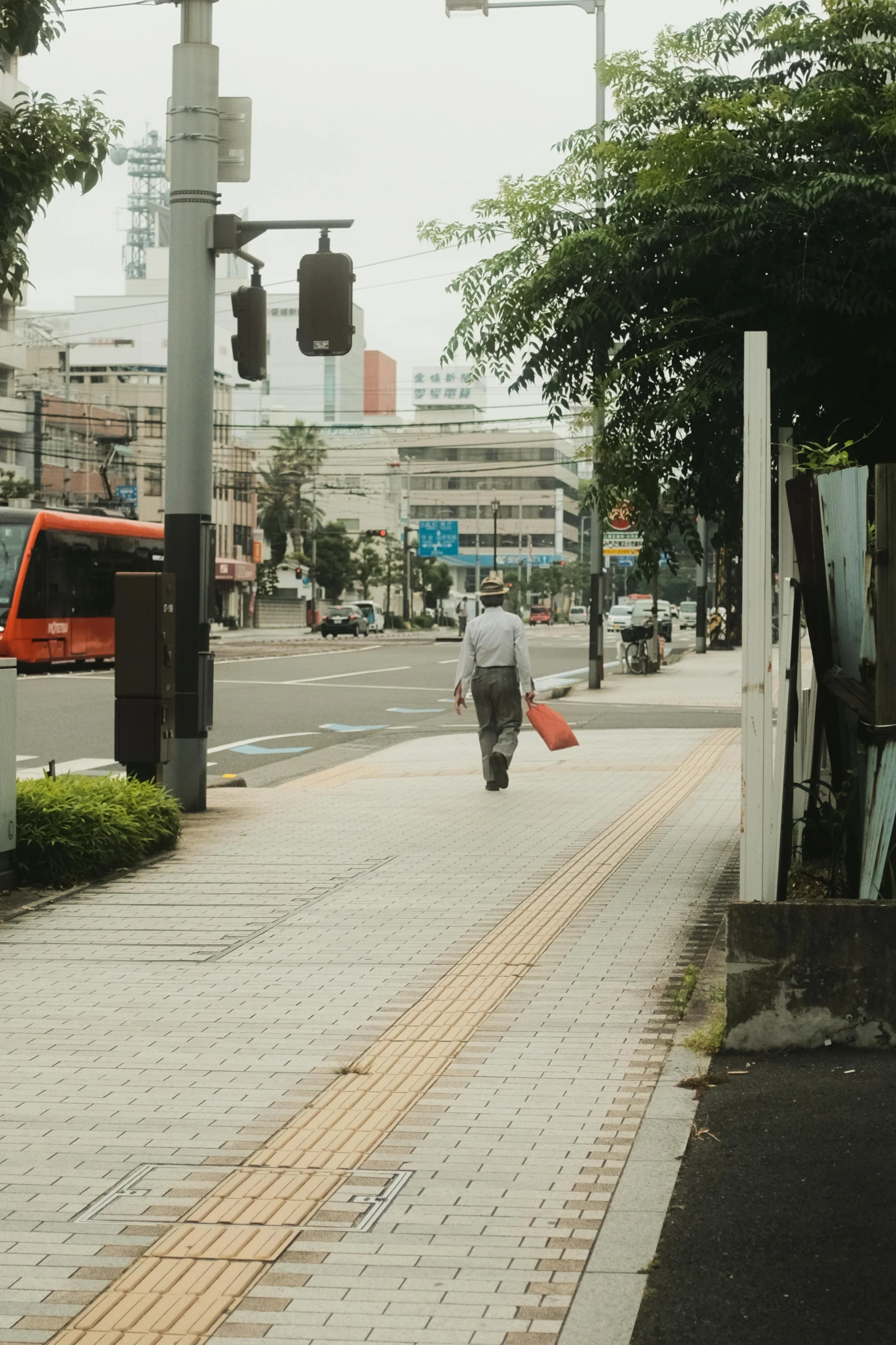 a man crossing a street with an umbrella