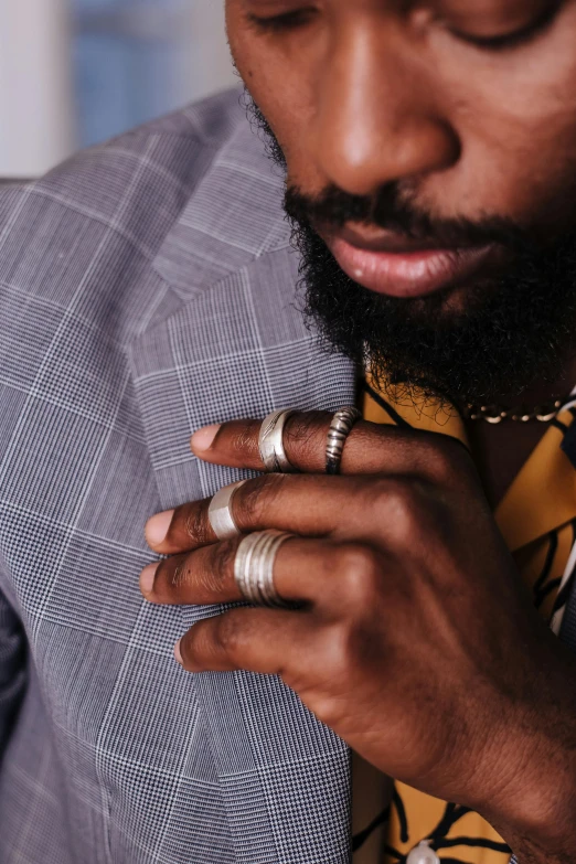 a man with his hands clasped around his tie