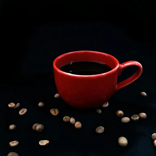 a red cup filled with liquid and peanuts