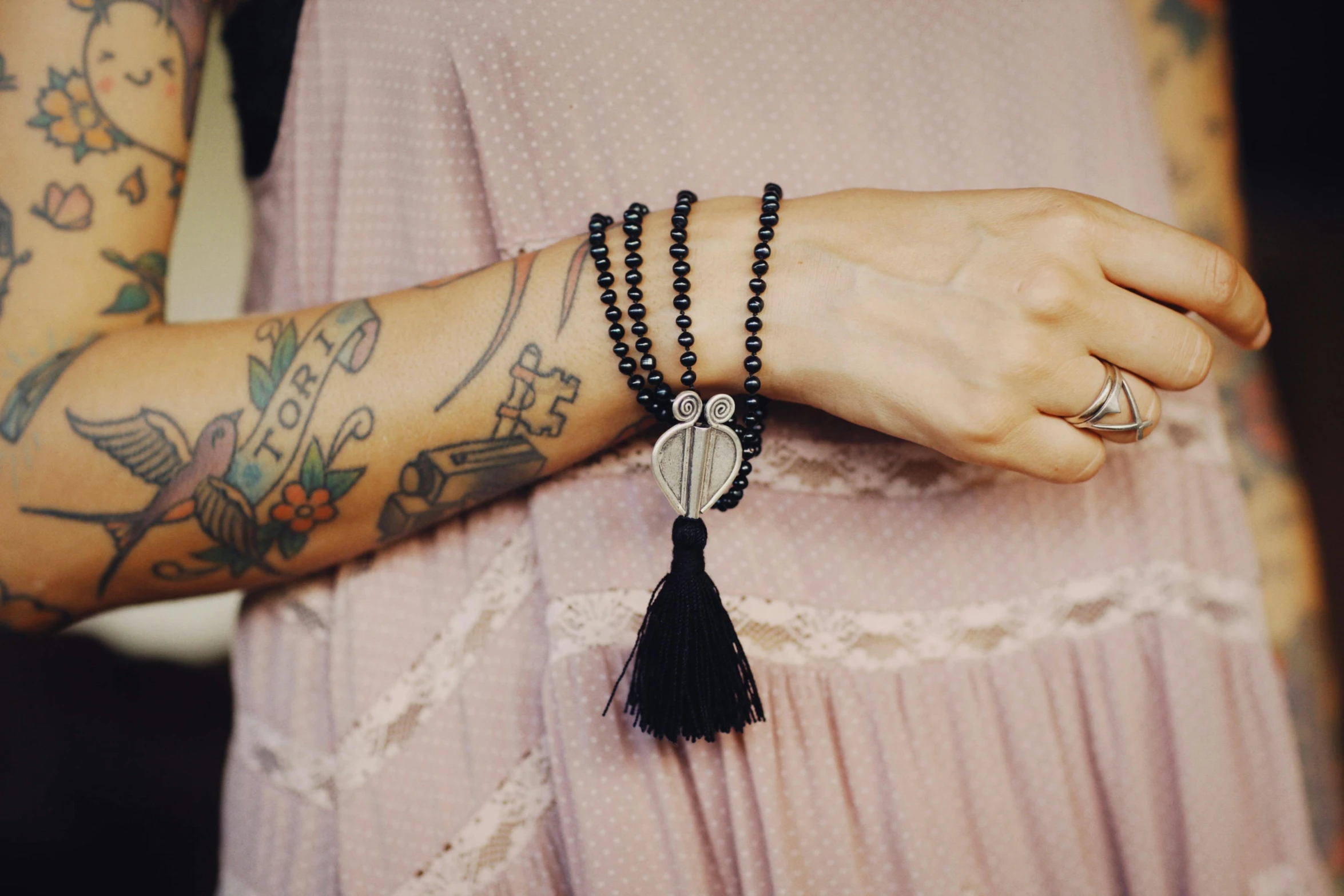 woman wearing celets with tassel and owl on top