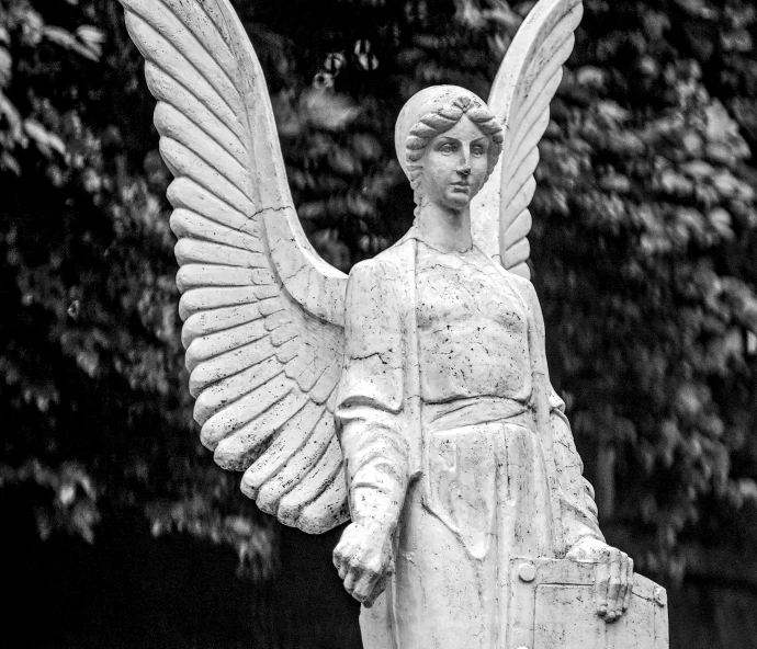 a statue of a angel holding a briefcase