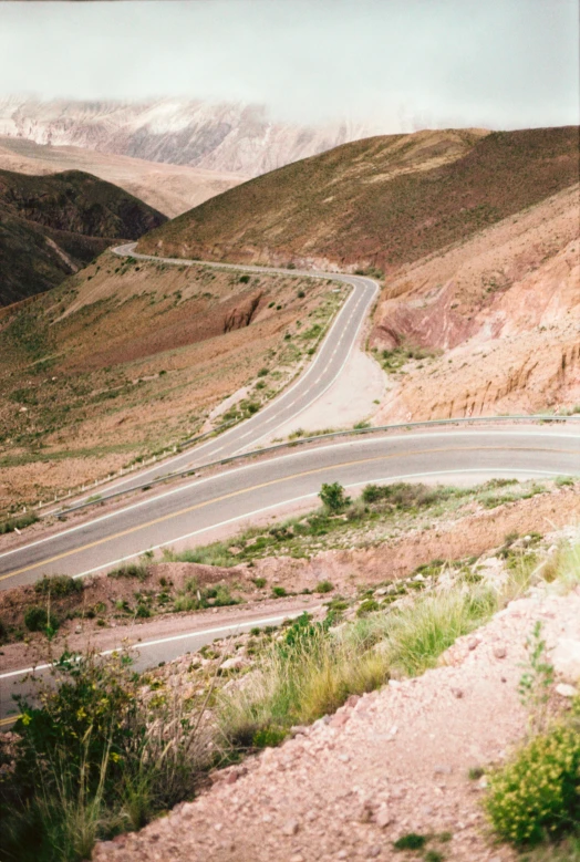 a view of a mountain road and mountains