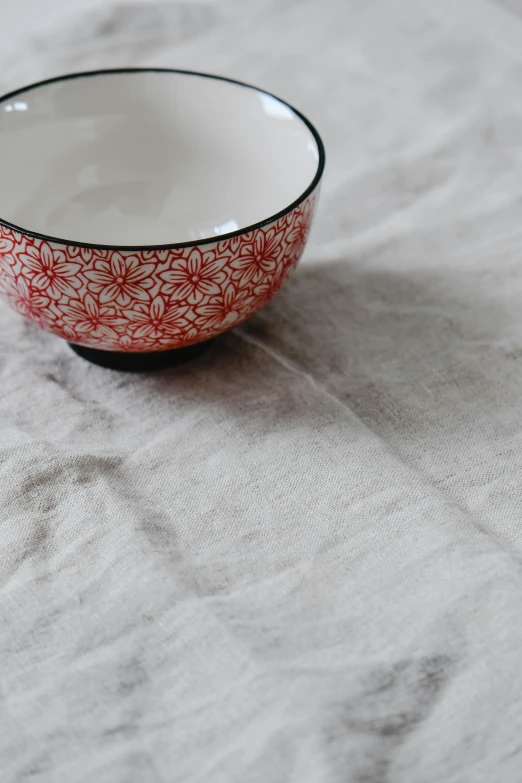 red and white bowl sitting on a table