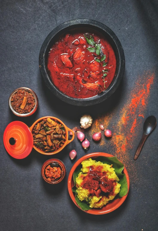 a bowl with soup in it and two dishes containing vegetables