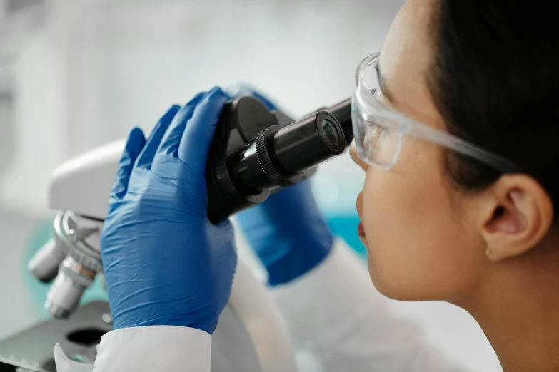 a laboratory worker in the process of observing