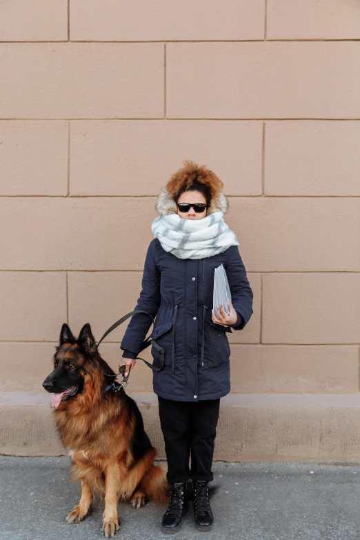 a person standing next to a brown dog