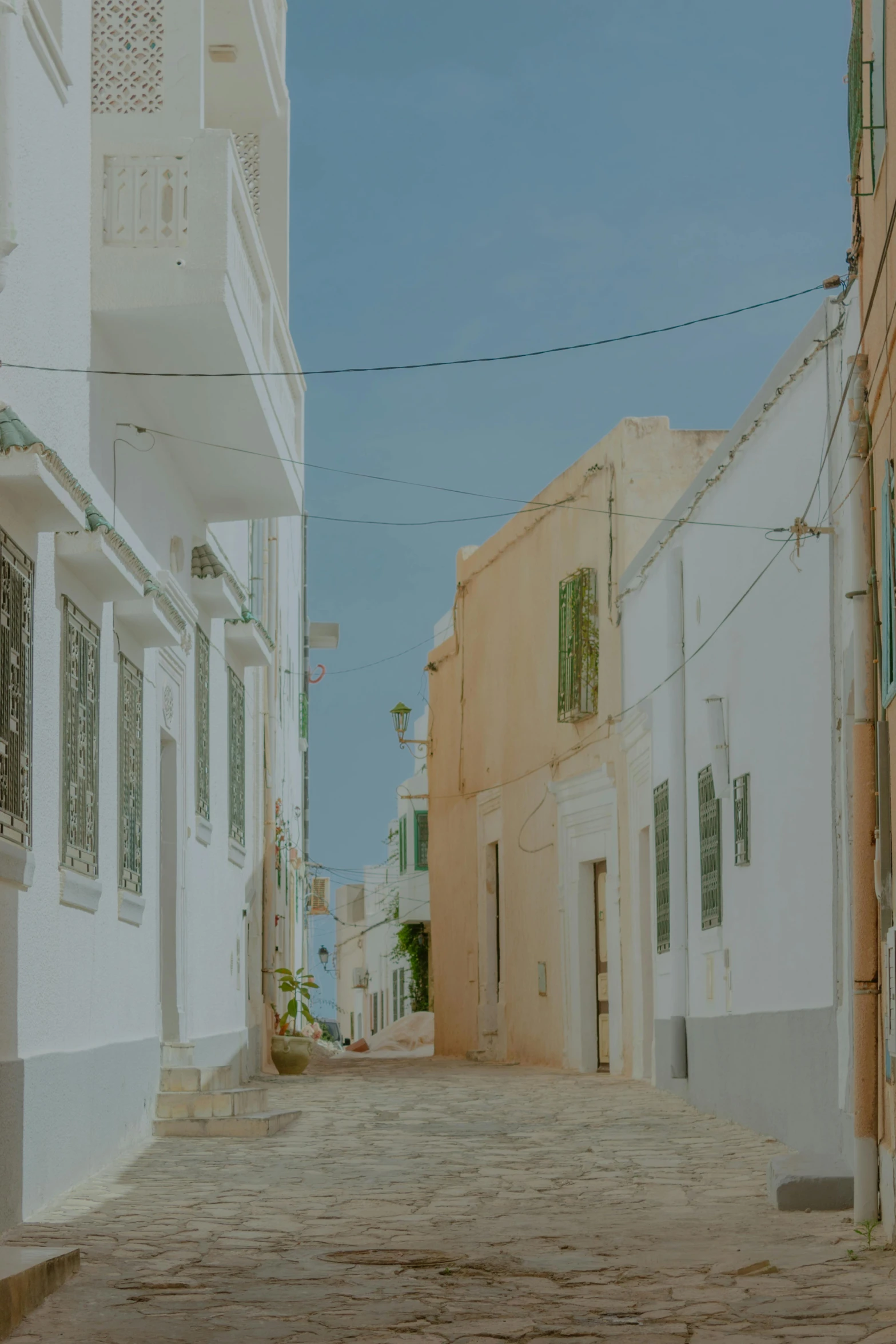 a narrow cobbled stone street with houses