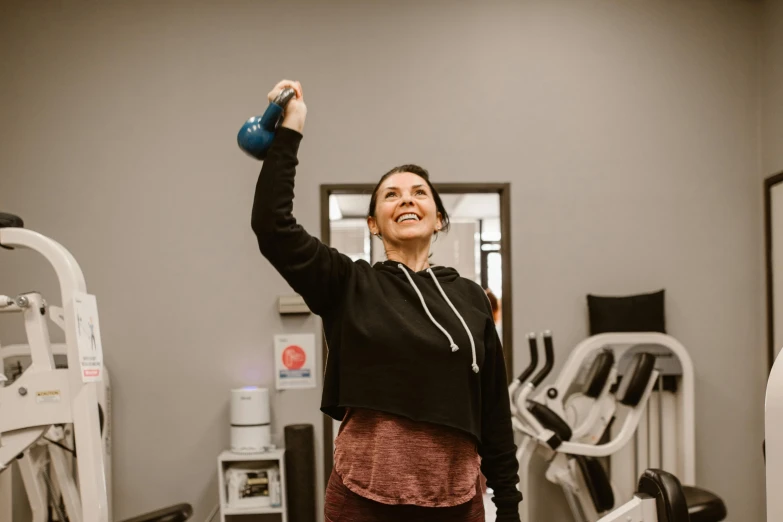 a woman holds a blue medicine bottle in her hand