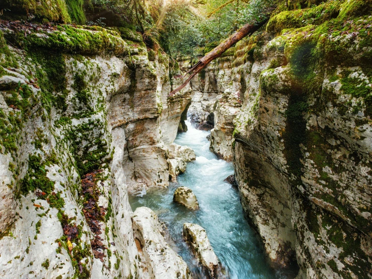 a stream flowing through the rocks in a valley