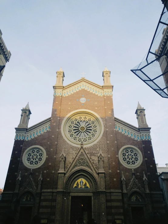 a large church with large round windows on the front