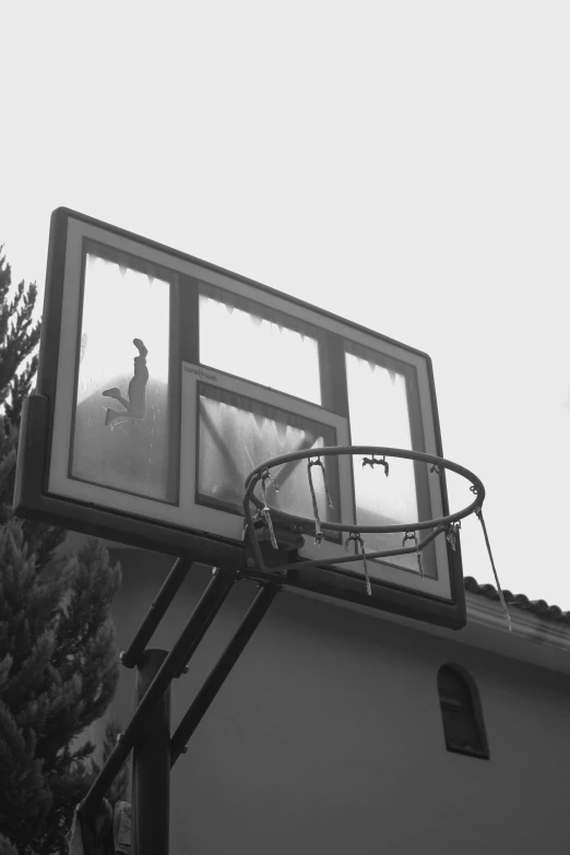 an outdoor basketball hoop on the roof of a home