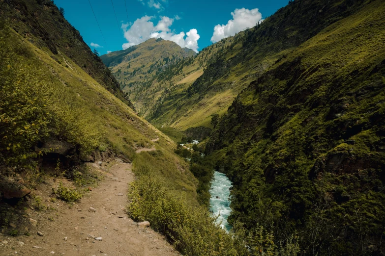 the stream is moving through an unpaved valley